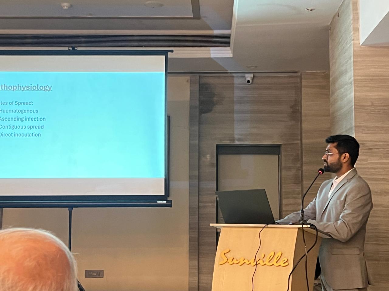 Dr. Pratap presenting at the podium